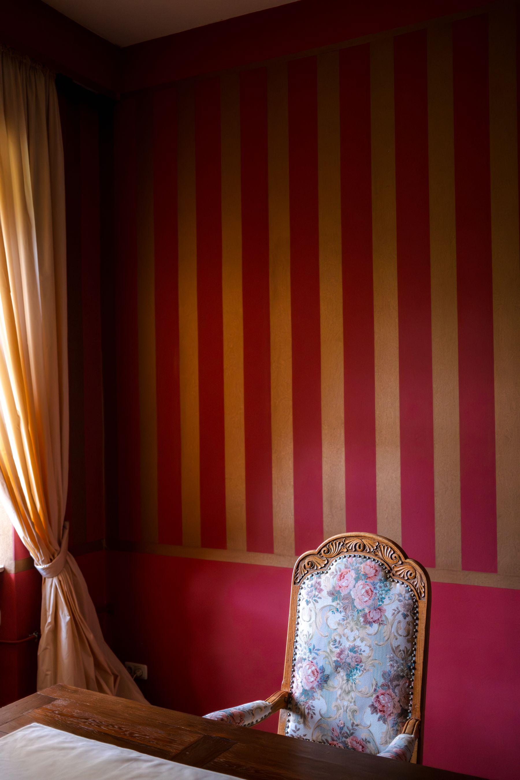 Red striped wallpaper in a vintage interior