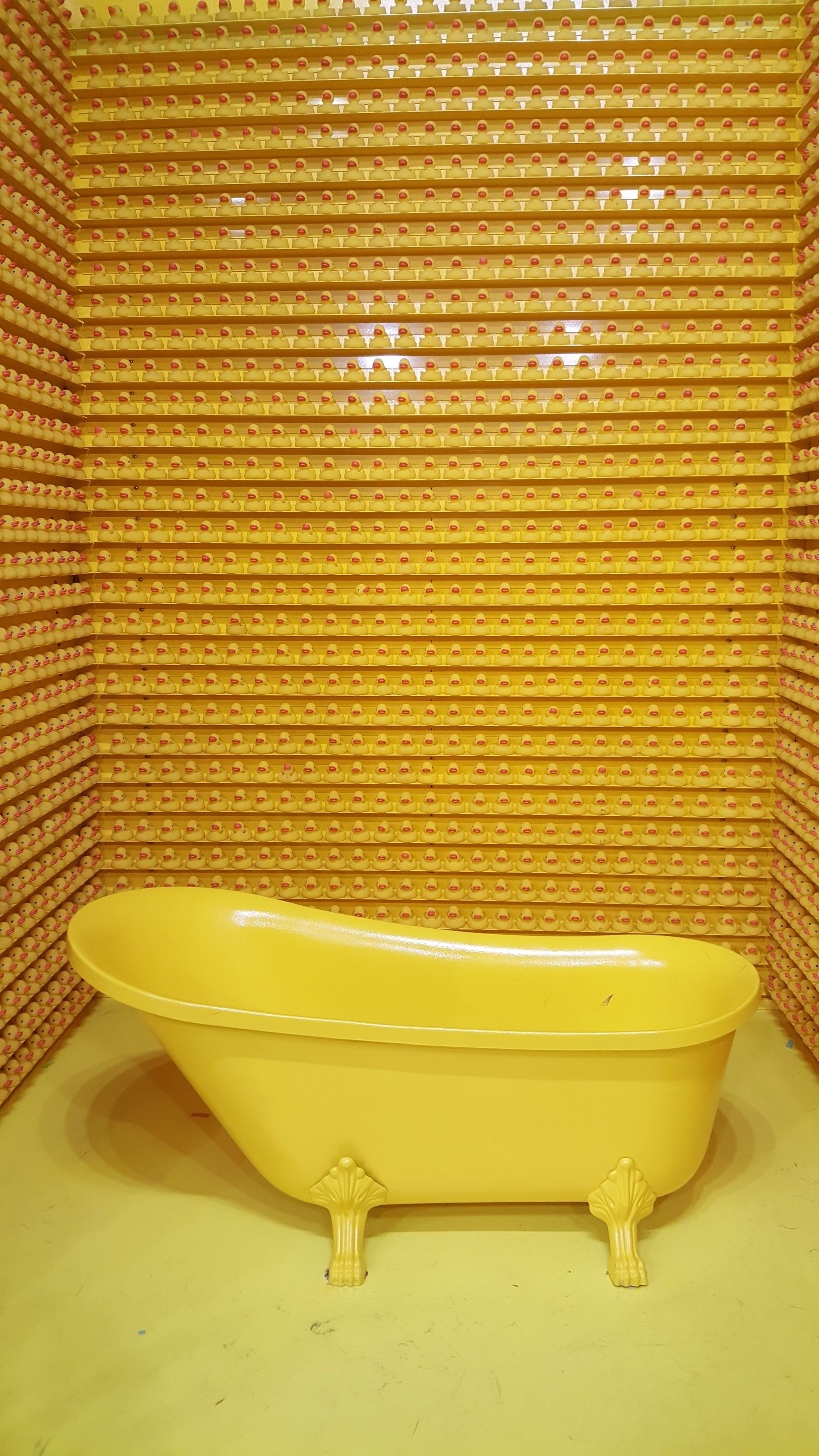 Bright yellow bathroom with patterned wallcovering